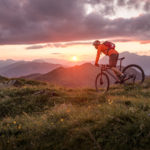 Male mountainbiker at sunset in the mountains