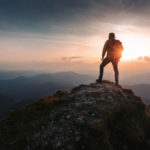 Tourist man hiker on top of the mountain. Active life concept